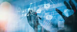 A hand interacts with virtual data visualizations, including graphs and charts, on a blue-toned digital interface—symbolizing data analysis, technology, and the insights gained from FinOps Cloud Financial Management Professional Certification.