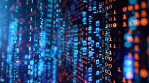 Digital visualization with rows of glowing blue and orange binary code (ones and zeros) on a dark background, symbolizing data processing, programming, or cyber technology.