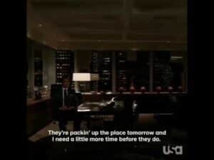 A man sits alone at his desk in a dimly lit office at night, city lights shining through large windows. White subtitles read: They’re packin up the place tomorrow and I need a little more time—career advice every young person could use.